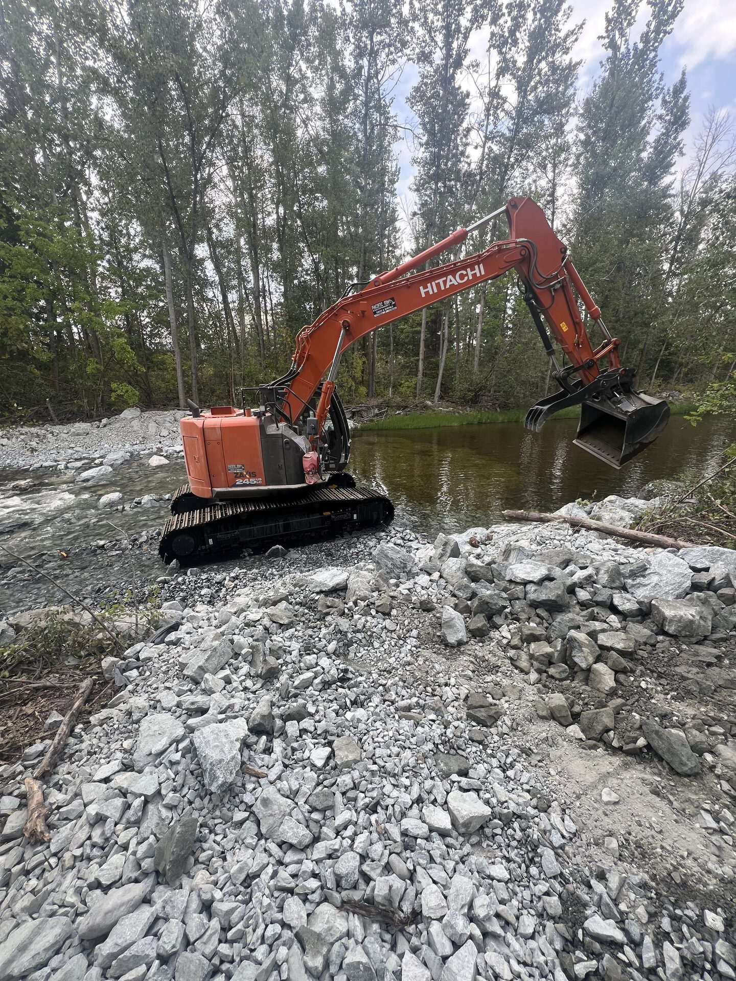 Hitachi excavator on a river restoration and bank stabilization site